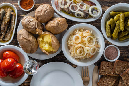 Simple rustic ukrainian food on wooden table, close up, top view. Variety of cooked vegetables and food in plates, Ukraineの写真素材