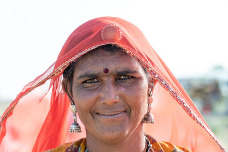 PUSHKAR, INDIA - NOVEMBER 13, 2018: Indian woman in the desert Thar during Pushkar Camel Mela near holy city Pushkar, Rajasthan, Indiaのeditorial素材