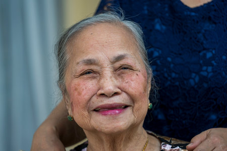 Hanoi, Vietnam - march 01, 2020: Beautiful Vietnamese old woman on the street in the old town of Hanoi, Vietnamのeditorial素材
