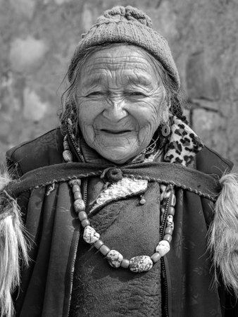 LAMAYURU, INDIA - JUNE 14, 2015: Buddhist old woman during mystical mask dancing Tsam mystery dance in time of Yuru Kabgyat Buddhist festival at Lamayuru Gompa, Ladakh, India, black and whiteのeditorial素材