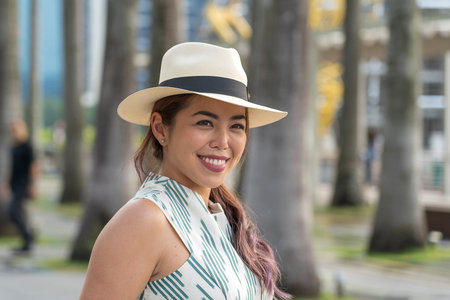 SINGAPORE CITY, SINGAPORE - MARCH 29, 2019: Young asian woman are photographed against the...