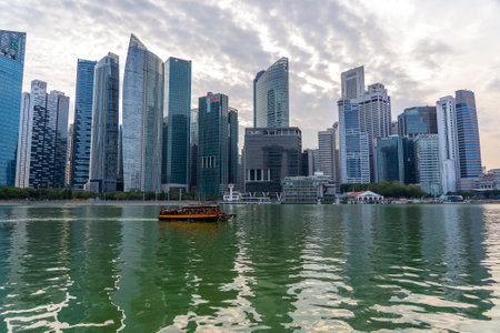 SINGAPORE CITY, SINGAPORE - MARCH 29, 2019: Singapore Skyline and view of skyscrapers on Marina Bay on a background of sky and clouds during the sunset. Singapore cityscape of the financial districtのeditorial素材