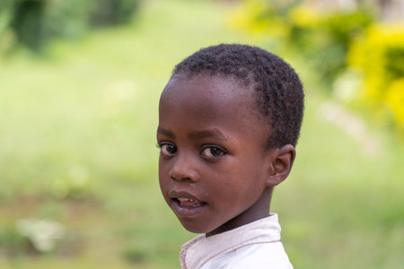 Arusha, Tanzania - December 20, 2019: Unknown african young happy boy on a street in Arusha, Tanzania, East Africa, close upのeditorial素材
