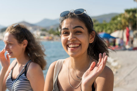 Bodrum, Turkey - September 09, 2019: Tourists girls walking on the beach near sea in the old town of Bodrum, Turkeyのeditorial素材