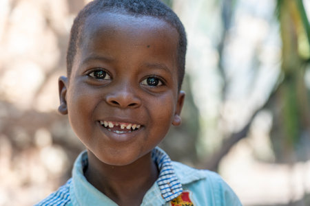 Zanzibar, Tanzania - november 16, 2019: Unknown african young happy boy on a street of Zanzibar island, Tanzania, East Africa, close upのeditorial素材