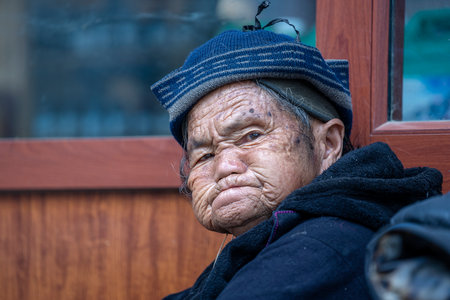 Sapa, Vietnam - march 02, 2020: Ethnic poor old Hmong woman on the street in Sapa town, North Vietnamのeditorial素材