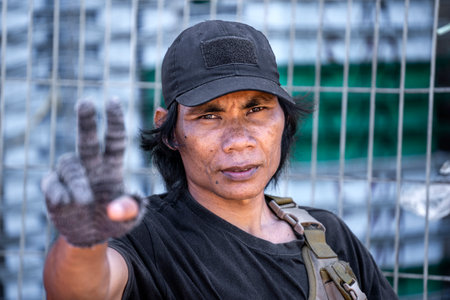 Kota Kinabalu, Malaysia - February 25, 2020: Portrait of a Malaysian male worker at a street Philippine fish market in Kota Kinabalu, Sabah, Malaysiaのeditorial素材