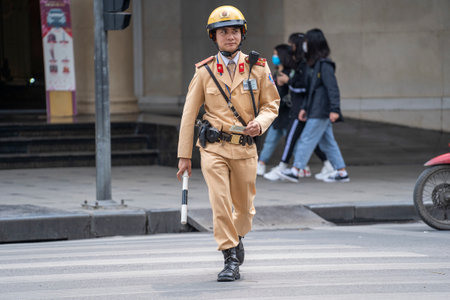 Hanoi, Vietnam - march 01, 2020: Vietnamese police officer on the street in the old town of Hanoi, Vietnamのeditorial素材