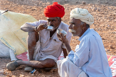 PUSHKAR, INDIA - NOVEMBER 14, 2018: Indian men in the desert Thar during Pushkar Camel Mela near...