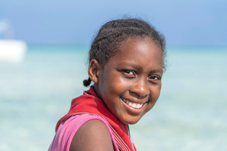 Zanzibar, Tanzania - january 03, 2020: Young African girl on the tropical beach in island of Zanzibar, Tanzania, east Africa, close upのeditorial素材