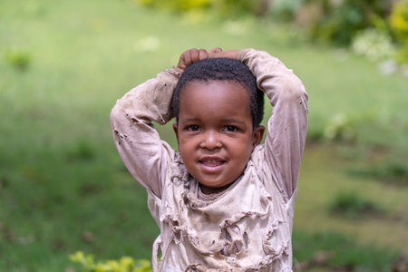 Arusha, Tanzania - December 20, 2019: Unknown african young happy girl on a street in Arusha,...