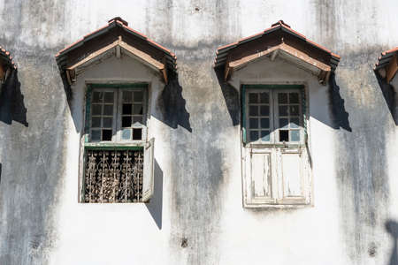 Old window with wooden shutters on white stucco wall in Stone Town on island Zanzibar, Tanzania, East Africaの写真素材