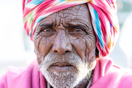 PUSHKAR, INDIA - NOVEMBER 14, 2018: Indian man in the desert Thar during Pushkar Camel Mela near...