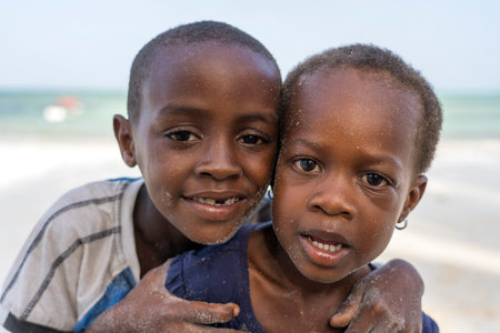 Zanzibar, Tanzania - january 15, 2020: Young African children on a tropical beach near sea on the island of Zanzibar, Tanzania, east Africa, close upのeditorial素材