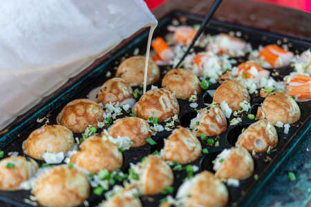 Coconut rice balls is traditional Thai dessert made from rice flour and coconut milk at street food market in Thailand, close upの写真素材