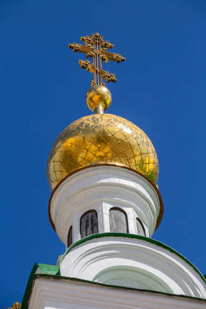 Beautiful domes of Christian Church on blue sky background, Kyiv, Ukraine