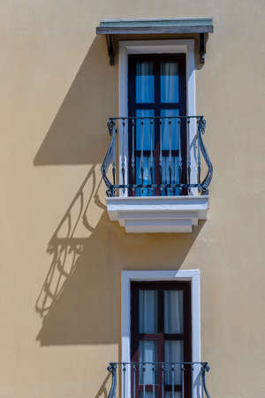 Windows with balcony on building facade with cast iron ornaments in Bodrum, Turkeyの写真素材