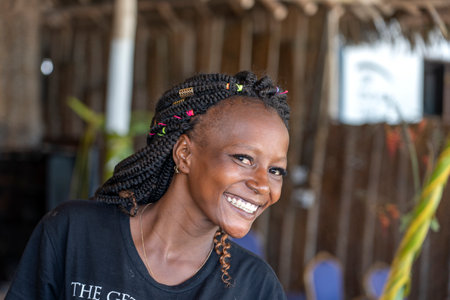 Zanzibar, Tanzania - january 04, 2020: African woman on the tropical beach cafe of Zanzibar island,...
