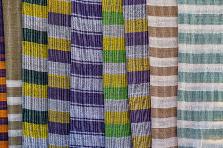 Handmade colorful Burmese fabric for sell in a tourist stall on the street market near Inle Lake in Burma, Myanmar. Close upの写真素材