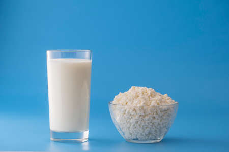 Glass of white milk isolated on blue background, close up. Dairy product concept, copy spaceの写真素材