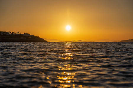 Beautiful sunrise over sea water in Sharm El Sheikh, Egypt. Travel and nature concept. Morning sky, sun and sea waterの写真素材