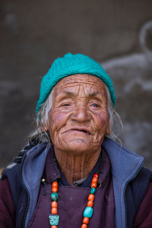 Lamayuru Gompa, Ladakh, India - June 14, 2015: Old Buddhist woman on the street next to the monastery Lamayuru in Ladakh, North Indiaのeditorial素材