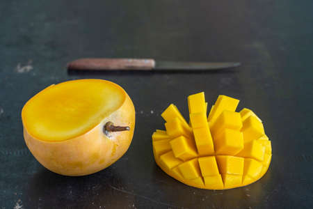 Fresh organic mango slices on wooden table, close up. Thailandの写真素材
