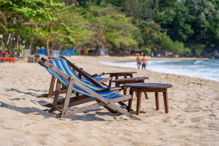 Wooden table and chairs in empty beach cafe next to sea water Close up. Island Koh Phangan, Thailandの写真素材