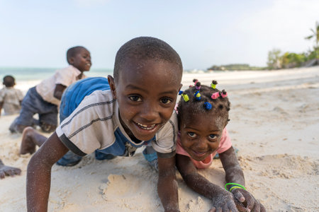 Zanzibar, Tanzania - january 15, 2020: Young African children on a tropical beach near sea on the island of Zanzibar, Tanzania, east Africa, close upのeditorial素材
