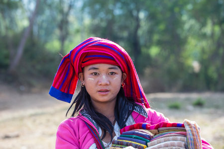 Inle Lake, Myanmar, Burma - Jan 12, 2016: Young girl with Tanaka on her face at a street food market near Inle Lake, Burma, Myanmar. Tanaka is a yellowish-white cosmetic paste made from crushed barkのeditorial素材