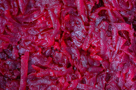 Grated fried red beetroot for salad, close up. Beetroot slice background or texture. Top viewの写真素材
