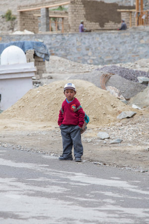 Lamayuru Gompa, Ladakh, India - June 16, 2015: Young boy going home from school after lessons at the local school at Lamayuru Gompa, Ladakh, North Indiaのeditorial素材