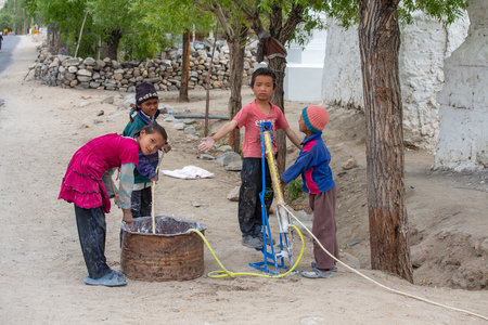 Leh, India - June 24, 2015: Tibetan children in a street in mountain village Leh, Ladakh region, north Indiaのeditorial素材