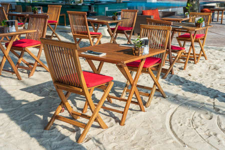 Wooden table and chairs in empty beach cafe next to sea. Close up. Island Koh Phangan, Thailandの写真素材
