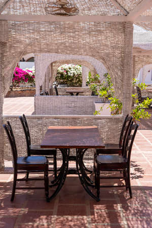 Wooden table and chairs in beach cafe next to the red sea in Sharm el Sheikh, Egypt, close upの写真素材