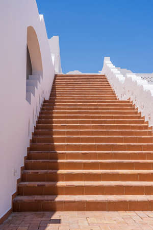 Detail of stairs and white wall of a house on the street of Egypt in Sharm El Sheikh, architecture...