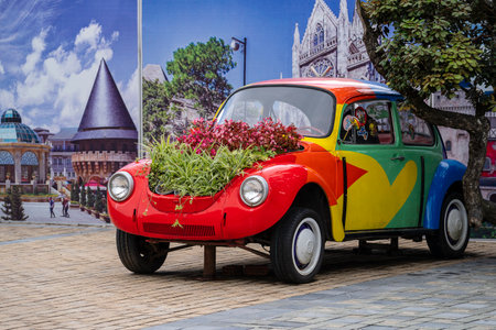 Danang, Vietnam - April 30, 2020: Flower bed in the open trunk of an old vintage car on the sidewalk outside on the street in city Da Nang, Vietnamのeditorial素材