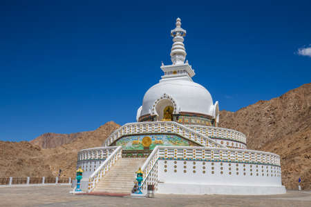 White buddhist stupa or pagoda in tibetan monastery near village Leh in ladakh region, noth Indiaの写真素材