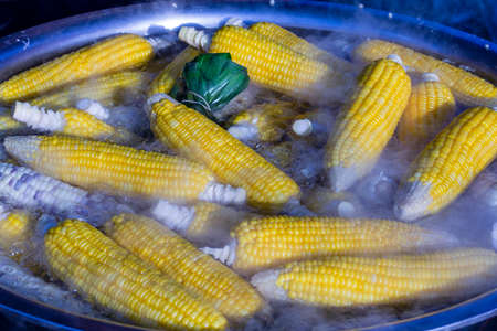 Corn boil in a saucepan on the street food market in Thailand, close up