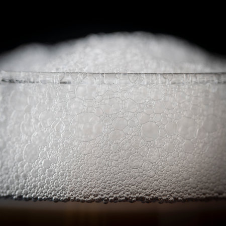 Part of a glass of cold drink with white froth, close upの写真素材
