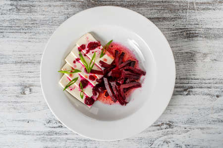 Boiled beet salad with soft feta cheese and sauce, close up, top viewの写真素材