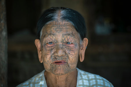 Kyee Chaung, Myanmar - Jan 27, 2016: Portrait of old Chin woman with web spider tattoo on face in village near Mrauk U region. Chin people, also known as the Kukis are a number of Tibeto Burman tribalのeditorial素材