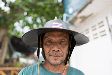 Koh Phangan, Thailand - Jan, 23, 2022 : Old man in traditional thai hat on the street market in island Koh Phangan,Thailand. close upのeditorial素材