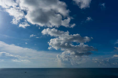 Natural daylight and white clouds floating on blue sky at sunny day over the seaの写真素材