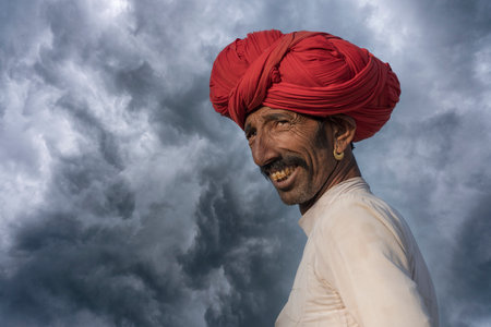 Pushkar, India - Nov 14, 2018: Indian man in the desert Thar during Pushkar Camel Mela near holy...