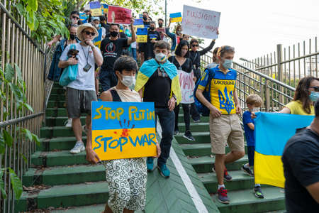 Bangkok, Thailand - Feb, 27, 2022 : Demonstrators, holding banners and Ukrainian flags, protested...