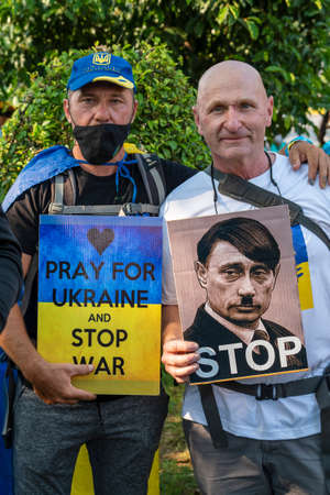 Bangkok, Thailand - Feb, 27, 2022 : Demonstrators, holding banners and Ukrainian flags, protested...
