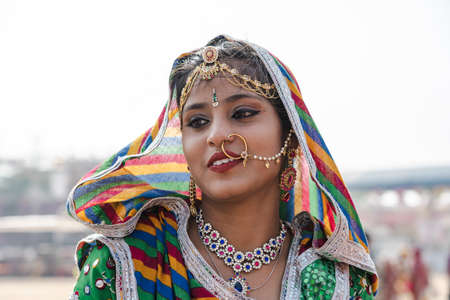 Pushkar, India - Nov 16, 2018 : Indian girl wearing traditional Rajasthani dress participate in Desert Festival in Pushkar, Rajasthan, Indiaのeditorial素材