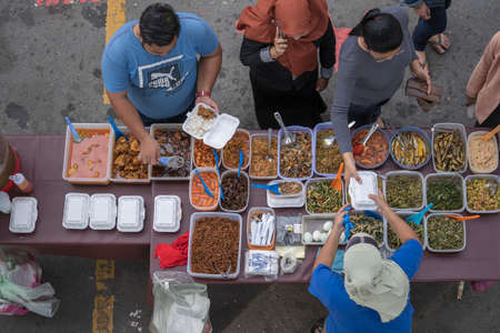 Kota Kinabalu, Malaysia - february 24, 2020 : street food seller preparing traditional of Malaysian food for people in night market at Kota Kinabalu, island Borneo, Malaysiaのeditorial素材