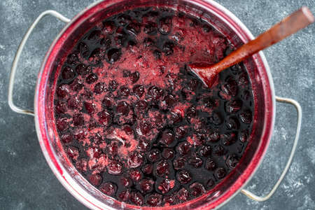 Preparation of freshly picked red cherries with sugar to make cherry jam, close up, top viewの写真素材
